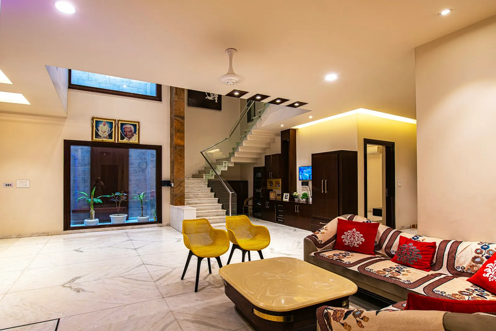 Spacious living room renovation with beamed ceiling and large windows